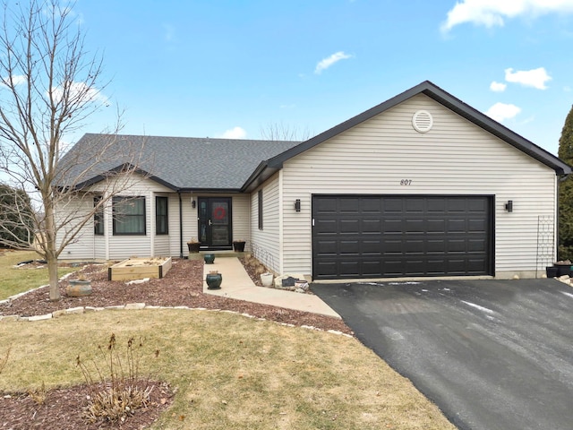 ranch-style home with a garage and a front yard