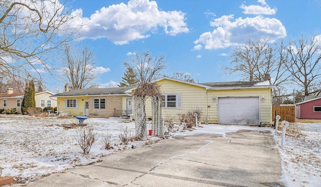 ranch-style home with a garage and driveway