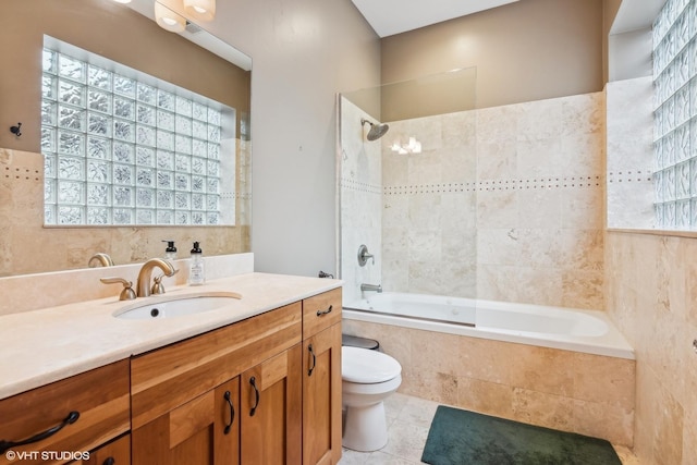 full bathroom with vanity, tile patterned floors, toilet, and tiled shower / bath