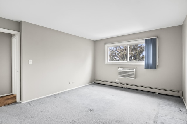 carpeted empty room with a wall unit AC and a baseboard heating unit