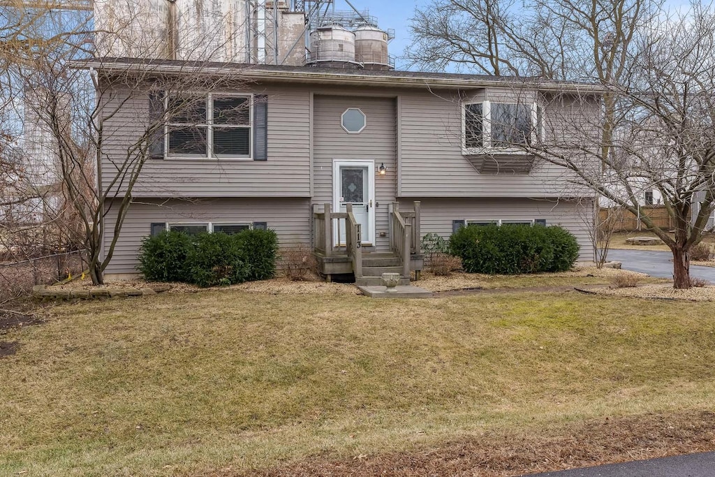 raised ranch with a front lawn