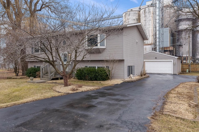 exterior space featuring an outbuilding, a garage, and a front lawn