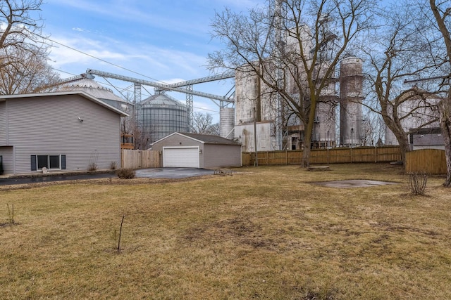 view of yard featuring a garage and an outbuilding