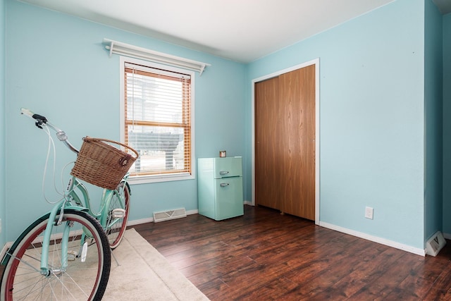 unfurnished room with dark wood-type flooring