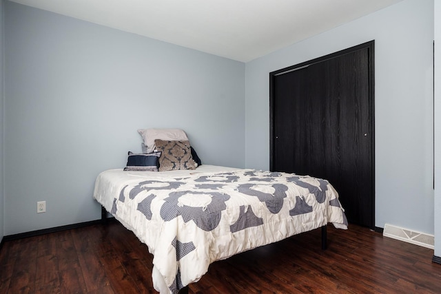 bedroom featuring dark hardwood / wood-style flooring