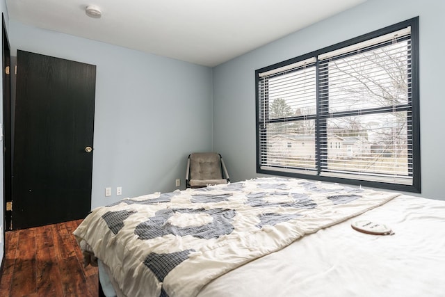 bedroom with dark hardwood / wood-style flooring