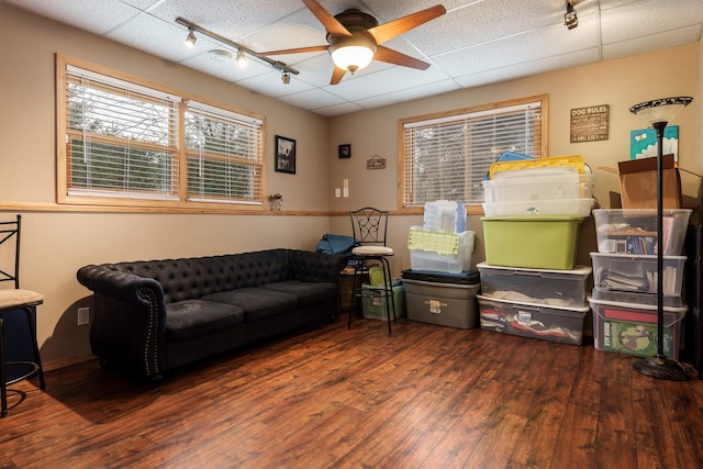 living room featuring dark hardwood / wood-style flooring, a paneled ceiling, ceiling fan, and track lighting