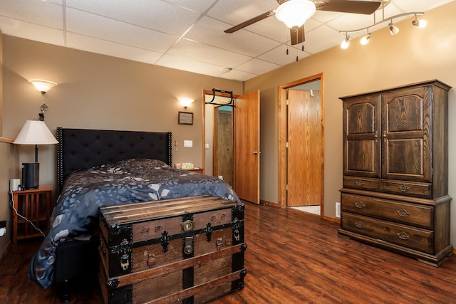 bedroom featuring dark hardwood / wood-style floors and a drop ceiling