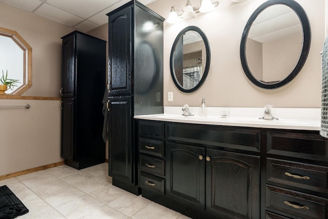 bathroom featuring a drop ceiling, vanity, and tile patterned floors