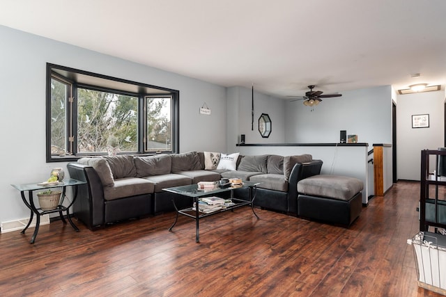 living room with dark hardwood / wood-style flooring and ceiling fan