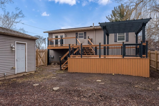 rear view of house with a deck and a pergola