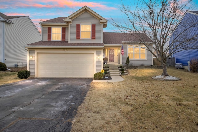 view of front of property featuring a yard and a garage