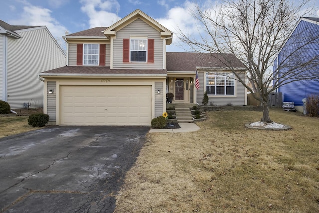 view of front of home with a garage and a front lawn