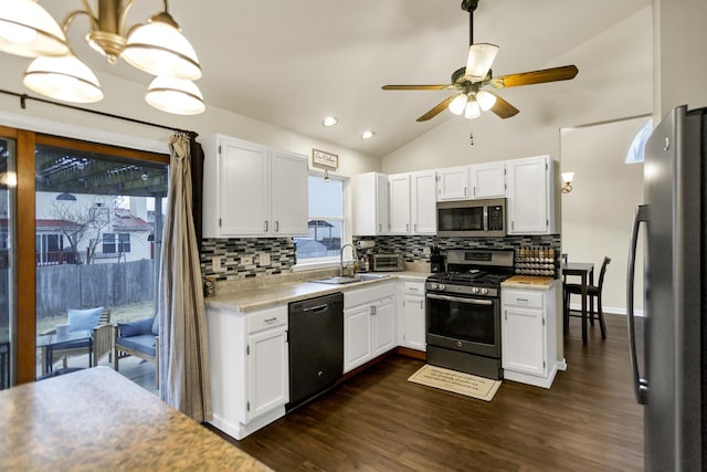 kitchen with white cabinetry, sink, backsplash, hanging light fixtures, and stainless steel appliances