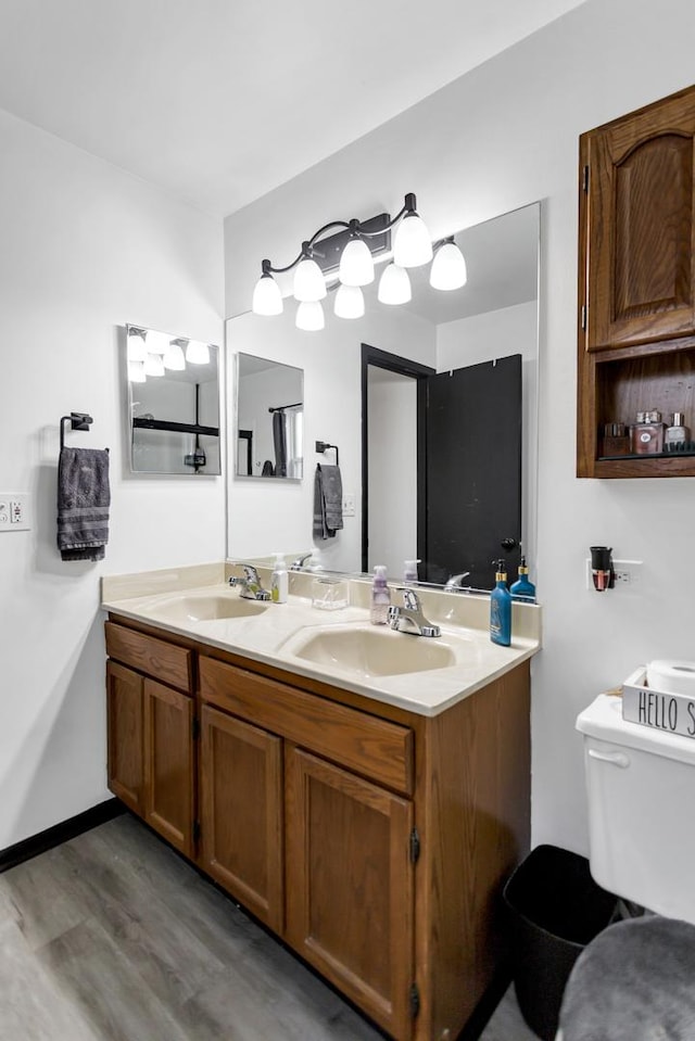 bathroom with vanity, hardwood / wood-style floors, and toilet