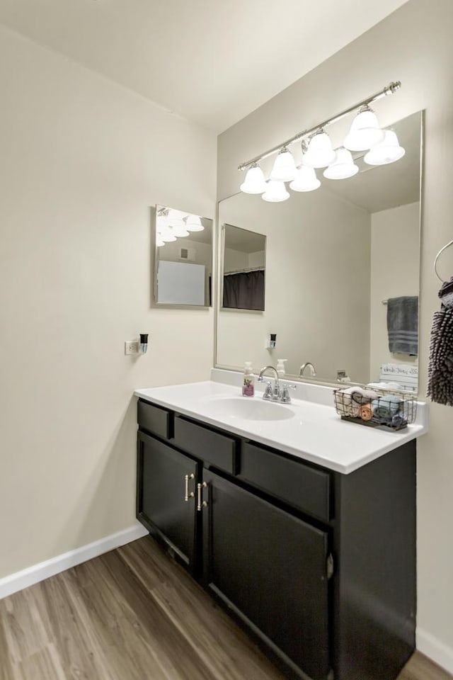 bathroom with hardwood / wood-style flooring and vanity