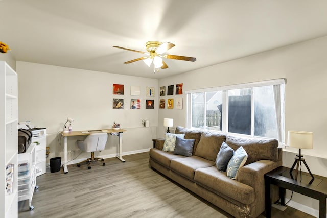 living room featuring ceiling fan and hardwood / wood-style floors