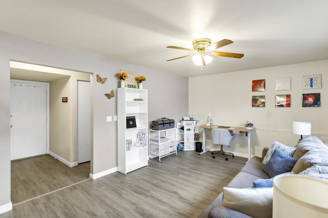 living room with hardwood / wood-style flooring and ceiling fan