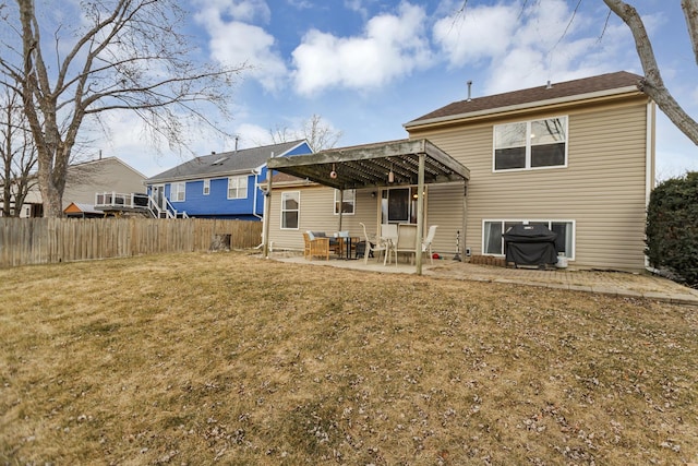 back of property with a yard and a patio