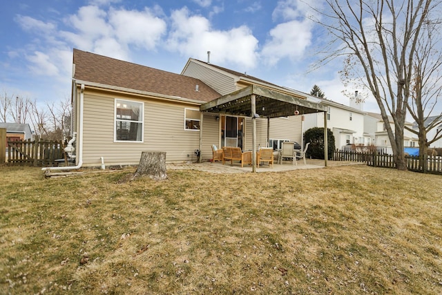 back of house with a patio area and a lawn