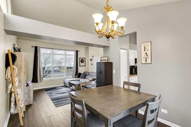 dining room featuring dark hardwood / wood-style flooring and a notable chandelier