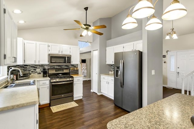 kitchen featuring appliances with stainless steel finishes, decorative light fixtures, sink, white cabinets, and decorative backsplash