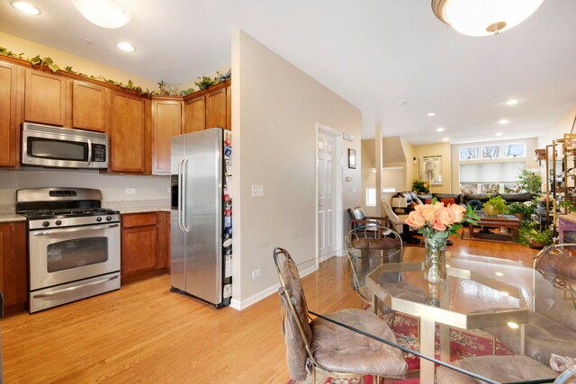 5405 W Galewood Ave, Chicago, IL 60639 - kitchen with stainless steel appliances, light stone countertops, and light wood-type flooring