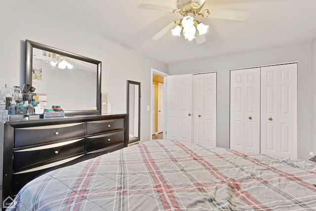 bedroom with two closets and ceiling fan