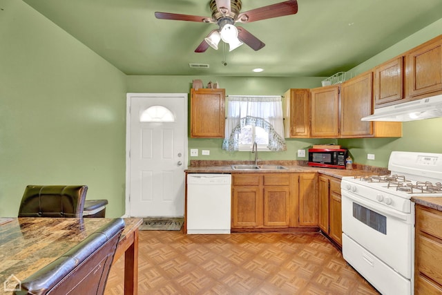 kitchen featuring ceiling fan, white appliances, light parquet flooring, and sink