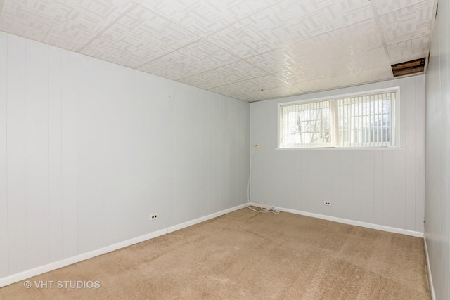 carpeted empty room featuring baseboards