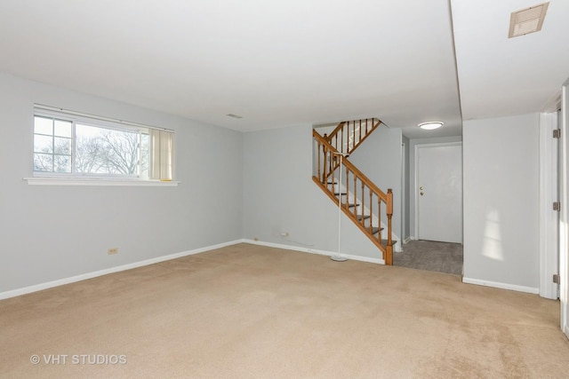 unfurnished room featuring carpet, stairs, visible vents, and baseboards