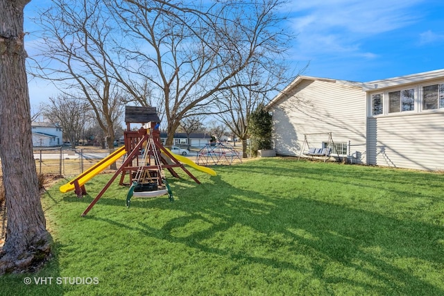 view of yard featuring a playground and fence