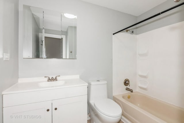 bathroom featuring vanity, toilet, and bathing tub / shower combination