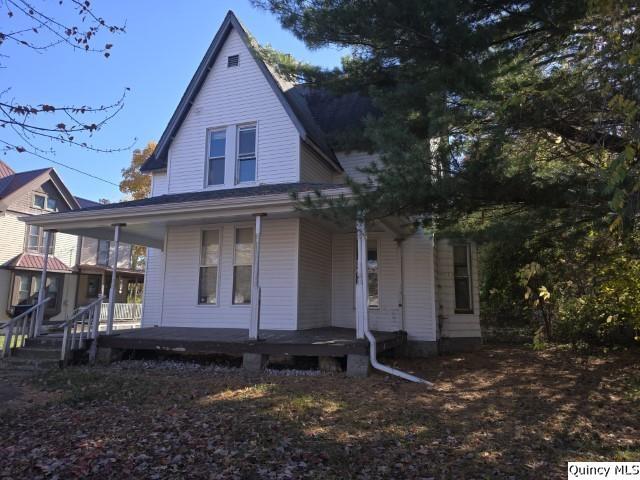 back of property with covered porch