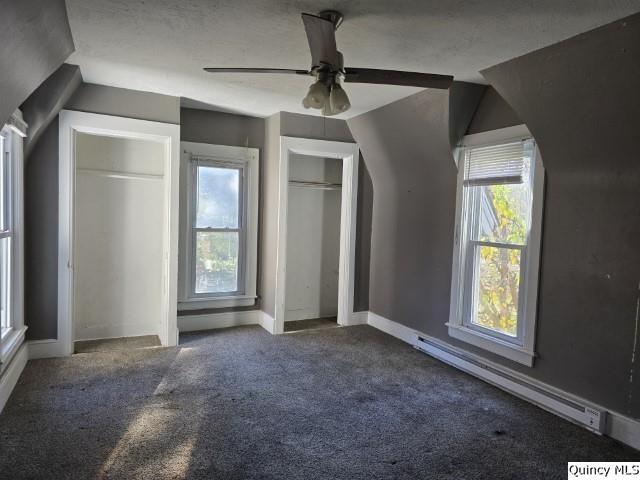 bonus room with vaulted ceiling, a baseboard radiator, and carpet