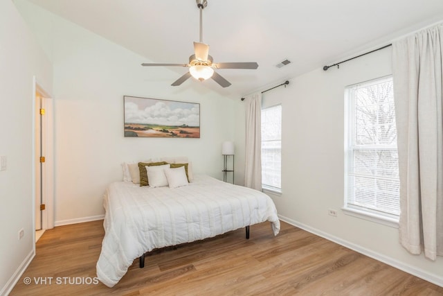 bedroom with hardwood / wood-style flooring, ceiling fan, and lofted ceiling