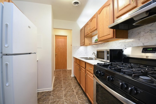 kitchen with sink, decorative backsplash, and stainless steel appliances