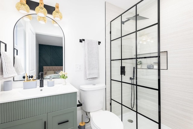 bathroom with vanity, toilet, and a tile shower