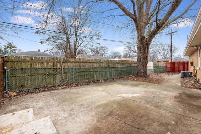 view of yard with central AC unit and a patio