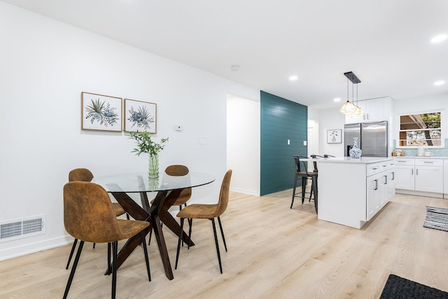 dining area with light hardwood / wood-style flooring