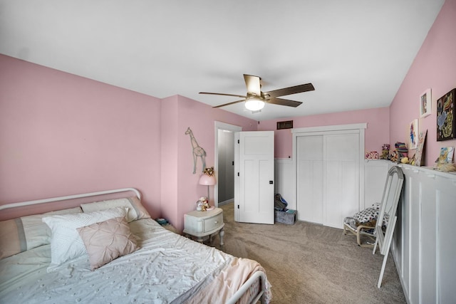 carpeted bedroom with ceiling fan and a closet