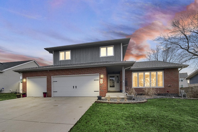 view of front of home with a yard and a garage