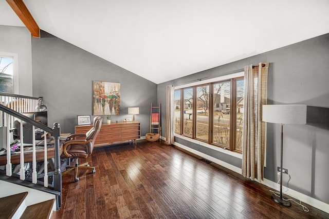 office space featuring dark hardwood / wood-style flooring, vaulted ceiling with beams, and plenty of natural light