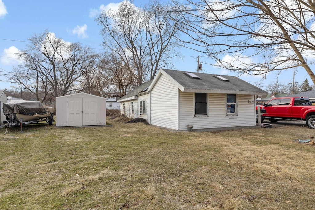 view of property exterior featuring a yard and a storage unit