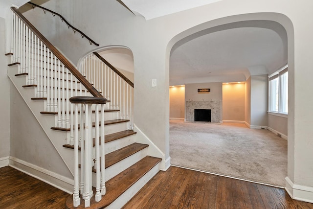 stairs featuring hardwood / wood-style floors