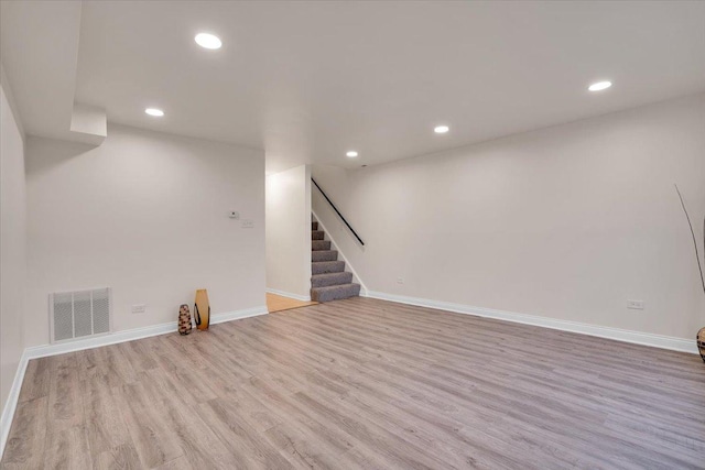 basement with light hardwood / wood-style flooring