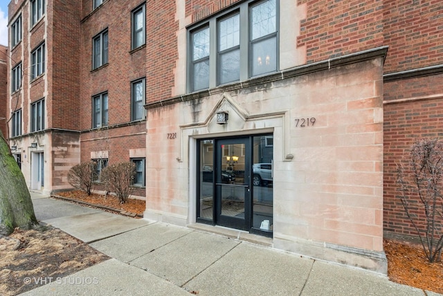 entrance to property with brick siding