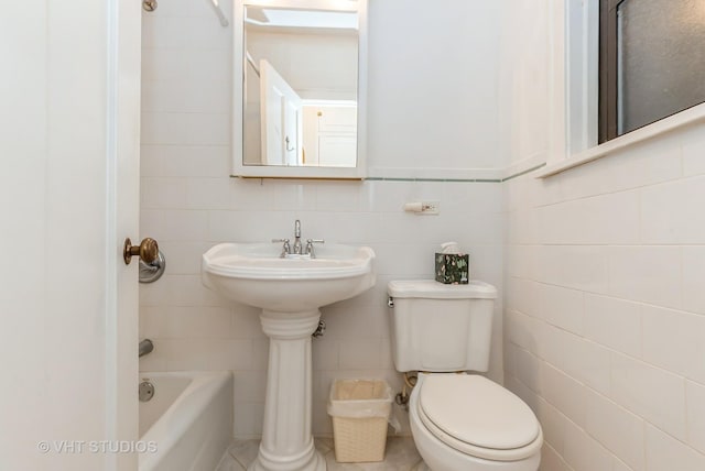 full bathroom featuring a shower, toilet, a tub, tile patterned flooring, and tile walls