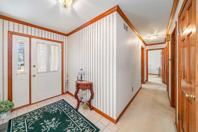 entrance foyer with crown molding, baseboards, visible vents, and wallpapered walls