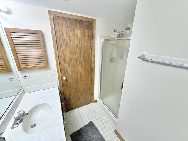 bathroom with walk in shower and vanity